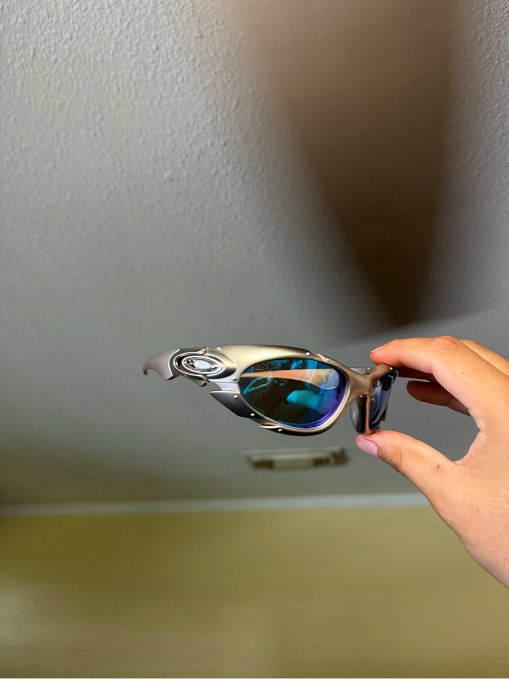 Oakley Silver Frame Sunglasses with Blue Mirrored Lenses